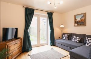 a living room with a couch and a tv at Pet-friendly 2 bed home near Chester train station. For 6 people. in Chester