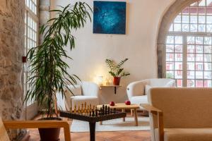 a living room with a chess board on a table at Hotel La Maison Oppoca in Ainhoa