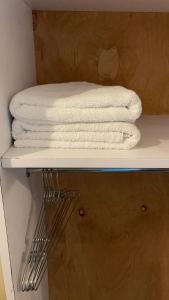 a stack of towels sitting on top of a shelf at Ample Residence in Nairobi