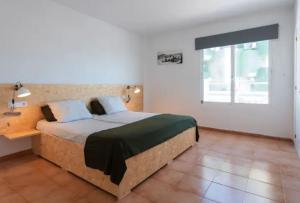 a bedroom with a bed with a desk and a window at Magaluf Beach I Calviá I Seaview I Apartment in Calvià