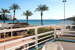 a balcony with a view of the beach and palm trees at Magaluf Beach I Calviá I Seaview I Apartment in Calvia Town