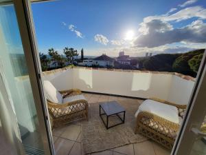 a balcony with chairs and a table and a view at Sapore di mare Luxury B&B and Cooking in Marbella