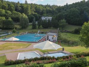 an overhead view of a swimming pool with an umbrella at Taunusblick-Meißner in Schmitten