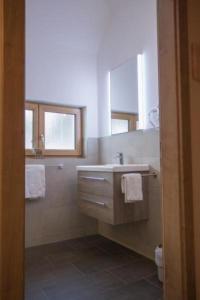 a bathroom with a sink and a mirror at Tolles Ferienhaus in Mauterndorf mit Sonniger Terrasse in Mauterndorf