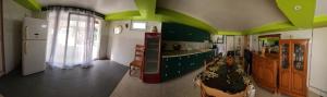 a kitchen with green walls and a kitchen with a counter at Maison de vacances in Saint-Amour