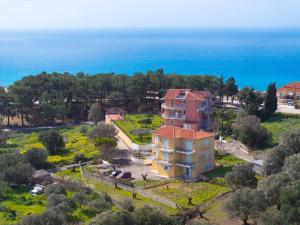 an aerial view of a house in front of the ocean at Kallithea Studios & Apts in Lakíthra
