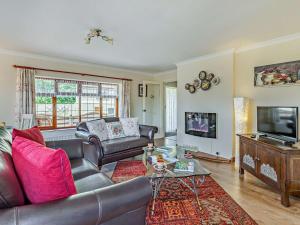 a living room with a leather couch and a television at 1 bed property in Taunton 58511 in Taunton