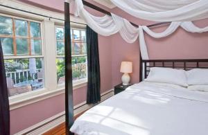 a bedroom with a bed and two windows at Skyline 3 BR 20 mins 2 TIME SQ #6 in West New York