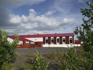 a red and white building with a red roof at Hotel Laxarbakki in Hvalfjarðarsveit