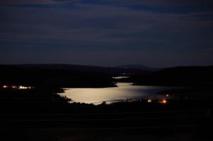 a view of a body of water at night at Monte do Azibo Glamping in Podence
