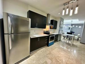 a kitchen with a stainless steel refrigerator and a table at Metropolitan Blue SK in Guatemala +21 photos