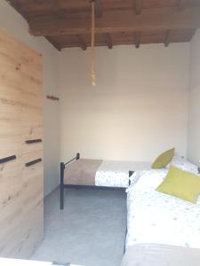 a bedroom with a bed in the corner of a room at Casa La Porriñesa in Porriño