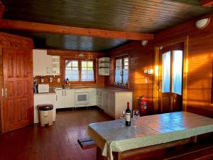 una cocina con una mesa con una botella de vino. en Tündér Farm en Zirc