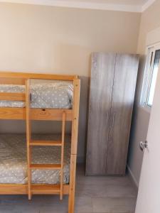 a bedroom with two bunk beds and a cabinet at Casa Giulia in Denia