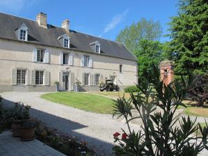 a large stone house with a driveway in front of it at Chateau Le Colombier in Brévands
