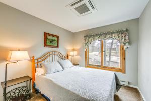 a bedroom with a bed and a window at Pristine Resort Townhome 2 Mi to Seven Springs Mtn in Champion
