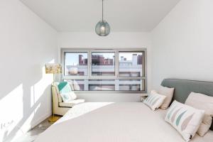 a white bedroom with a bed and a window at Lisbon South Bay Seixal in Seixal +38 photos