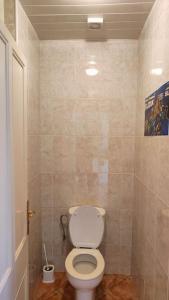 a bathroom with a white toilet in a room at Casa Bretalunya in Benissanet