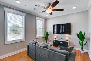 a living room with two couches and a flat screen tv at Modern Nashville Condo Walk to Local Breweries! in Nashville