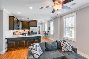 a living room with a couch and a kitchen at Modern Nashville Condo Walk to Local Breweries! in Nashville