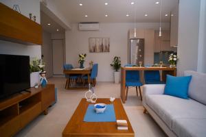 a living room with a couch and a table at Marant Luxury Apartment in Agios Rokkos