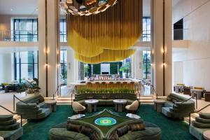 a hotel lobby with a large chandelier and a bar at W Hollywood in Los Angeles