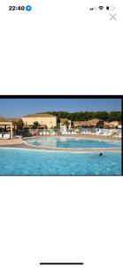 a television screen showing a swimming pool with a person in it at Maison in Béziers