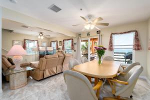 a dining room and living room with a table and chairs at Castaway Cottage in Fort Myers Beach