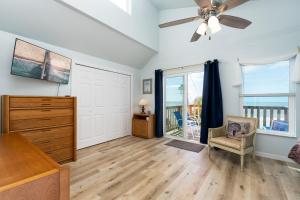 a living room with a ceiling fan and a dresser at Castaway Cottage in Fort Myers Beach