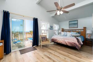a bedroom with a bed and a balcony at Castaway Cottage in Fort Myers Beach