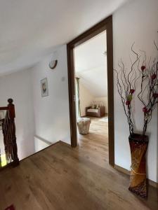 a room with a mirror and a vase with flowers at Casa Matei in Turda +21 photos