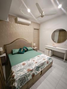 a bedroom with a bed and a mirror at Comfy Resedency in Lahore