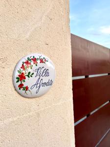 a sign on the side of a building at Villa Afrodite in San Pietro in Bevagna