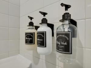a group of three soap bottles in a bathroom at Shoreline Solace: Ocean View Townhouse Tillamook in Tillamook