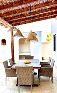 a dining room with a table and chairs at Villa Afrodite in San Pietro in Bevagna