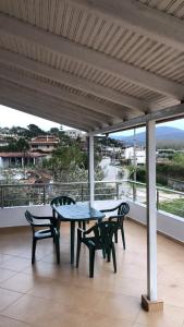 a patio with a table and chairs on a balcony at Eveline Boutique Apartments in Sarandë