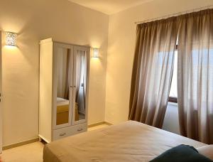 a bedroom with a bed and a large window at Villa Afrodite in San Pietro in Bevagna