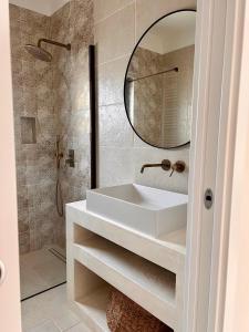 a bathroom with a white sink and a mirror at Villa Afrodite in San Pietro in Bevagna