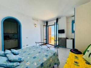 a bedroom with a bed and a kitchen with a view at YourHome - Dimora di Mare in Amalfi