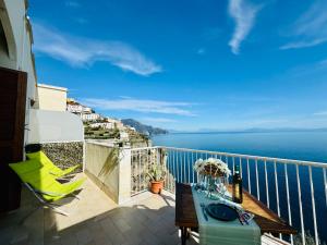 a balcony with a table and a view of the ocean at YourHome - Dimora di Mare in Amalfi