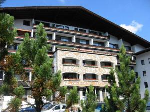 a large building with trees in front of it at MountainLOVE in Strobl