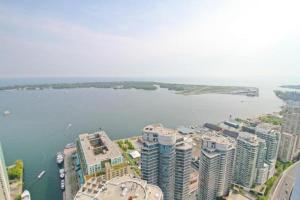 an aerial view of a city and a body of water at Presidential 2+1BR Condo, Entertainment District (Downtown) w/ CN Tower View, Balcony, Pool & Hot Tub in Toronto