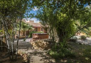a house with trees in front of a yard at Sierra Grande Lodge & Spa in Truth or Consequences