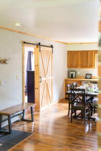 a kitchen with a table and a sliding barn door at Cozy Cabin in Stratton Mountain & Mount Snow 10min in Stratton