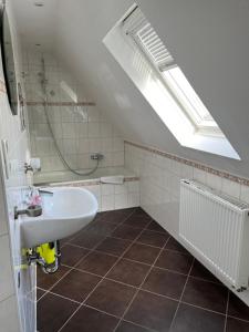 a white bathroom with a sink and a shower at Garis Pension Wesseln 