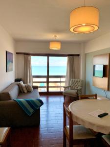 a living room with a couch and a table at Depto Frente Al Mar, Edificio Iskofema II in Miramar