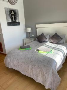 a bedroom with a large bed with pillows on it at Villa 20 in Caleta De Fuste