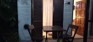 a table and chairs on a patio with a door at Palmeras Apart Hotel in Chascomús