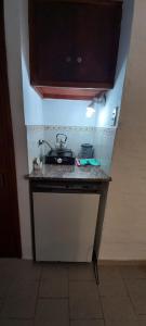 a kitchen counter with a stove on top of it at Palmeras apart hotel in Chascomús