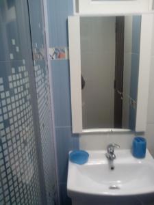 a bathroom with a sink and a mirror at Casa Matei in Turda
